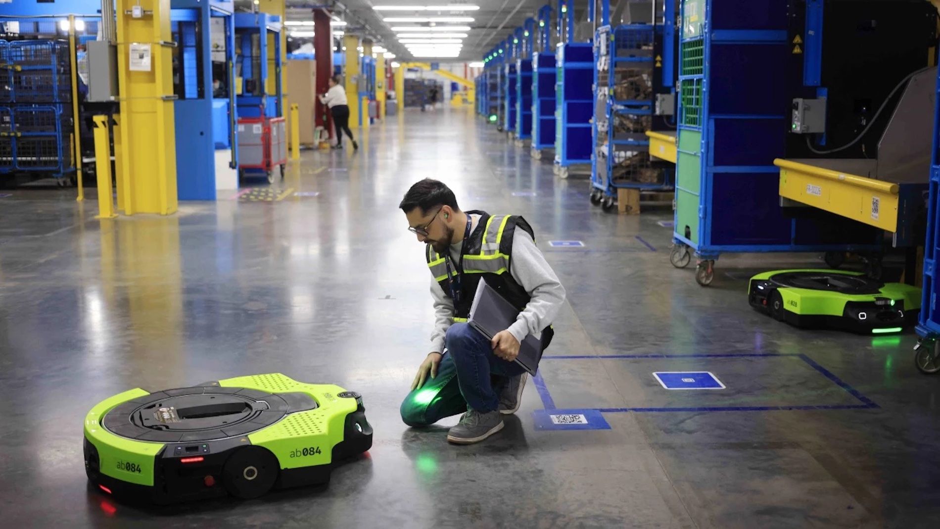 robot y trabajador almacen amazon